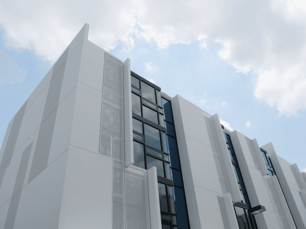 Modern office building seen from below against a blue sky