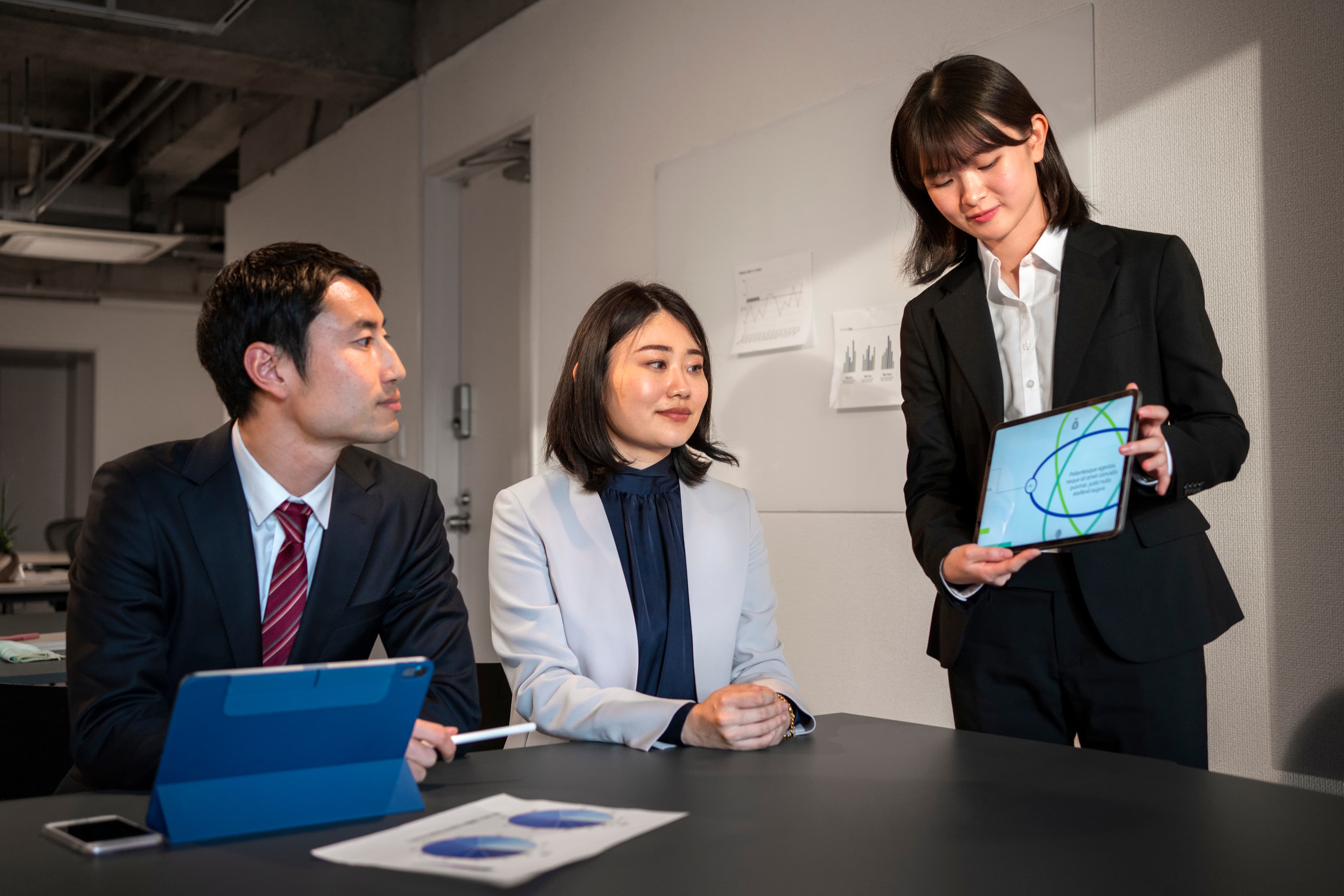 Two colleagues reviewing documents in an office