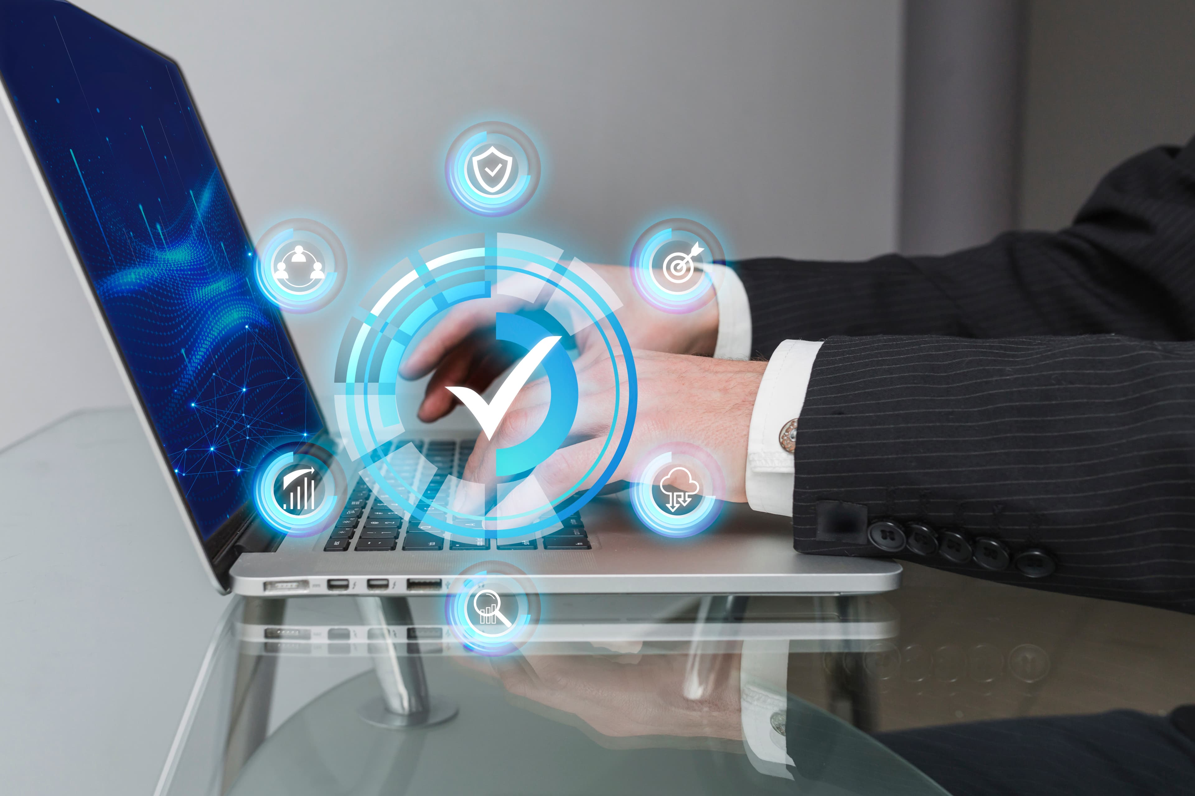 Hands typing on a laptop with workflow icons overlaid