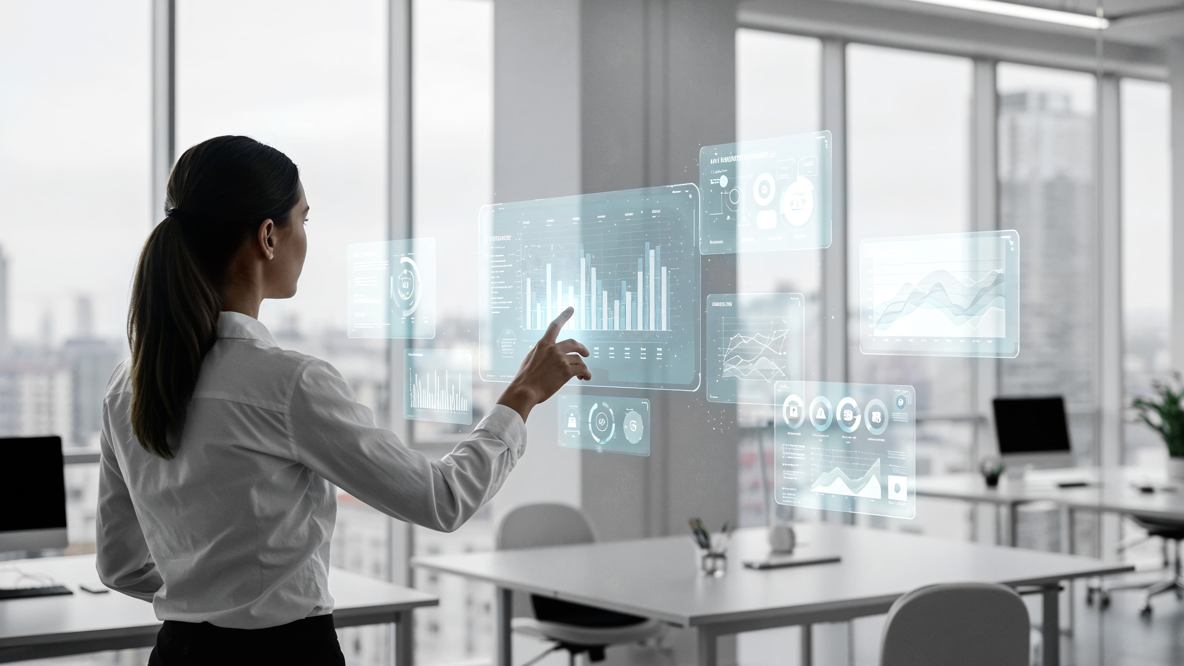 Analyst presenting charts on a large screen to a colleague